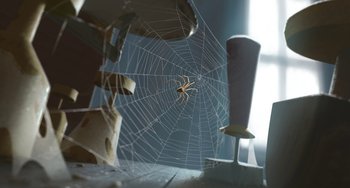 Movie still from “Klaus” (2019), directed by Carlos Martínez López – A spider sitting on a web in a room; Extreme Close Up shot, High angle