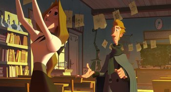 Movie still from “Klaus” (2019), directed by Carlos Martínez López – A man and a woman are standing in front of a table; Medium shot, Over the shoulder angle