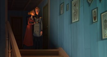 Movie still from “Klaus” (2019), directed by Carlos Martínez López – A cartoon of a man and a woman standing next to each other in front of a staircase; Wide shot, Low angle