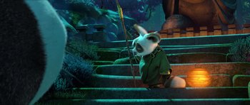 Movie still from “Kung Fu Panda 3” (2016), directed by Jennifer Yuh Nelson – A panda bear is sitting on some stairs; Medium shot, High angle