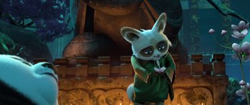 Movie still from “Kung Fu Panda 3” (2016), directed by Jennifer Yuh Nelson – A stuffed animal that is standing up and holding a flower; Medium shot, Low angle