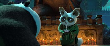 Movie still from “Kung Fu Panda 3” (2016), directed by Jennifer Yuh Nelson – A stuffed animal is standing in front of a fireplace; Close Up shot, Over the shoulder angle