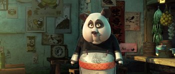Movie still from “Kung Fu Panda 3” (2016), directed by Jennifer Yuh Nelson – A panda bear is standing in front of a wall; Medium shot, High angle