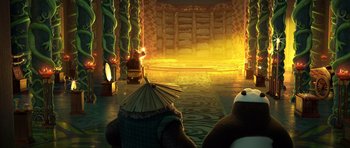 Movie still from “Kung Fu Panda 3” (2016), directed by Jennifer Yuh Nelson – A scene with a panda bear and a person in a hat; Wide shot, Low angle