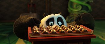 Movie still from “Kung Fu Panda 3” (2016), directed by Jennifer Yuh Nelson – A stuffed panda bear sitting on top of a keyboard; Medium shot, High angle