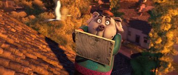 Movie still from “Kung Fu Panda 3” (2016), directed by Jennifer Yuh Nelson – A cartoon pig holding a sign in front of a forest; Medium shot, High angle