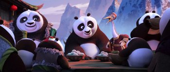 Movie still from “Kung Fu Panda 3” (2016), directed by Jennifer Yuh Nelson – A group of animals sitting on top of a wooden table; Medium shot, Over the shoulder angle