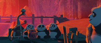 Movie still from “Kung Fu Panda 3” (2016), directed by Jennifer Yuh Nelson – Three panda bears sitting next to each other in front of a fire pit; Wide shot, Low angle
