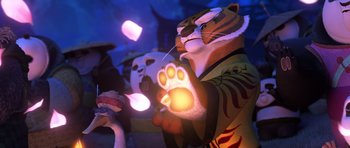 Movie still from “Kung Fu Panda 3” (2016), directed by Jennifer Yuh Nelson – A stuffed tiger with a cat in the background; Medium shot, Low angle