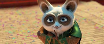 Movie still from “Kung Fu Panda 3” (2016), directed by Jennifer Yuh Nelson – A cartoon of a cat wearing a green and brown scarf; Close Up shot, High angle