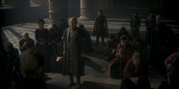 Movie still from “House of the Dragon” (2022), created by George R.R. Martin – A group of people sitting in a room; Wide shot, High angle