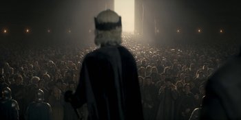 Movie still from “House of the Dragon” (2022), created by George R.R. Martin – A crowd of people standing in front of a judge; Wide shot, High angle