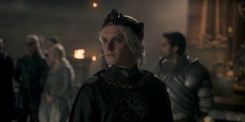 Movie still from “House of the Dragon” (2022), created by George R.R. Martin – A man wearing a crown in a dark room; Close Up shot, Over the shoulder angle