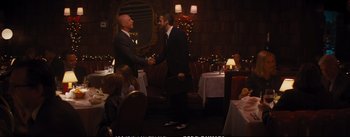 Movie still from “La La Land” (2016), directed by Damien Chazelle – Two men shaking hands in a restaurant; Wide shot, Over the shoulder angle