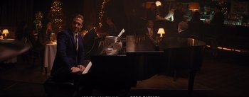 Movie still from “La La Land” (2016), directed by Damien Chazelle – A man sitting at a piano in a dark room; Medium shot, Over the shoulder angle
