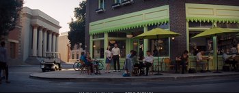 Movie still from “La La Land” (2016), directed by Damien Chazelle – A group of people sitting at a table outside of a restaurant; Extreme Wide shot, Over the shoulder angle