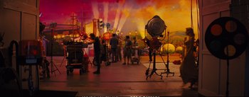 Movie still from “La La Land” (2016), directed by Damien Chazelle – A group of people standing in a room with lights; Wide shot, Over the shoulder angle