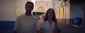 Movie still from “La La Land” (2016), directed by Damien Chazelle – A man and a woman standing next to each other on a street; Medium shot, Over the shoulder angle