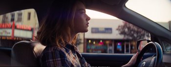 Movie still from “La La Land” (2016), directed by Damien Chazelle – A woman sitting in the back seat of a car looking out the window; Close Up shot, Over the shoulder angle