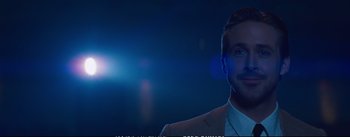 Movie still from “La La Land” (2016), directed by Damien Chazelle – A person wearing a suit and tie; Close Up shot, Over the shoulder angle