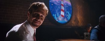 Movie still from “La La Land” (2016), directed by Damien Chazelle – A man in front of a light house picture; Close Up shot, Low angle
