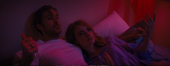Movie still from “La La Land” (2016), directed by Damien Chazelle – A man and a woman laying in a bed together; Medium shot, High angle