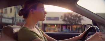 Movie still from “La La Land” (2016), directed by Damien Chazelle – A woman sitting in the driver's seat of a car; Close Up shot, Low angle