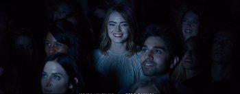 Movie still from “La La Land” (2016), directed by Damien Chazelle – A woman and a man smiling for the camera; Close Up shot, Over the shoulder angle
