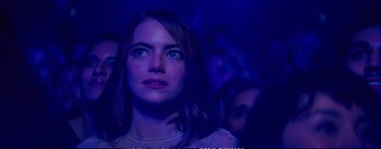 Movie still from “La La Land” (2016), directed by Damien Chazelle – A person in a dark room; Close Up shot, Over the shoulder angle