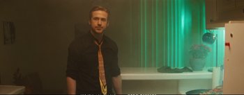 Movie still from “La La Land” (2016), directed by Damien Chazelle – A man in a black shirt and a yellow neck tie; Medium shot, Over the shoulder angle