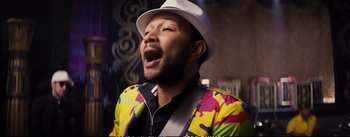 Movie still from “La La Land” (2016), directed by Damien Chazelle – A man with a white hat and a colorful jacket; Close Up shot, Overhead angle