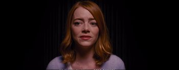 Movie still from “La La Land” (2016), directed by Damien Chazelle – A person with red hair; Close Up shot, Over the shoulder angle
