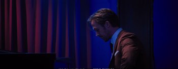 Movie still from “La La Land” (2016), directed by Damien Chazelle – A person wearing a suit and tie; Close Up shot, Over the shoulder angle