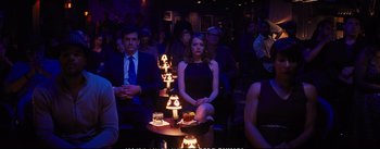 Movie still from “La La Land” (2016), directed by Damien Chazelle – A group of people sitting in a room with lit candles; Medium shot, High angle