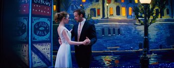 Movie still from “La La Land” (2016), directed by Damien Chazelle – A man and a woman dancing in front of a painting; Medium shot, Over the shoulder angle