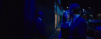 Movie still from “La La Land” (2016), directed by Damien Chazelle – A man and a woman standing next to each other in the dark; Medium shot, Over the shoulder angle