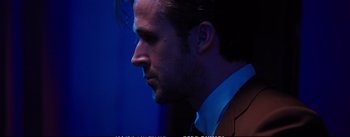 Movie still from “La La Land” (2016), directed by Damien Chazelle – A person wearing a suit and tie; Close Up shot, Over the shoulder angle