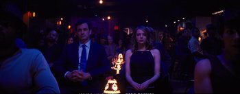 Movie still from “La La Land” (2016), directed by Damien Chazelle – A man and a woman sitting in front of candles on a table; Medium shot, Over the shoulder angle