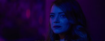Movie still from “La La Land” (2016), directed by Damien Chazelle – A person wearing a blue light; Close Up shot, Over the shoulder angle