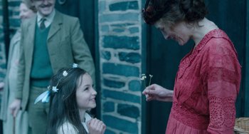 Movie still from “Lady Chatterley's Lover” (2022), directed by Laure de Clermont-Tonnerre – A young girl and an older woman holding flowers; Medium shot, Over the shoulder angle