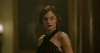 Movie still from “Lady Chatterley's Lover” (2022), directed by Laure de Clermont-Tonnerre – A woman in a black dress is posing for a picture; Close Up shot, Low angle
