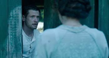 Movie still from “Lady Chatterley's Lover” (2022), directed by Laure de Clermont-Tonnerre – A man and a woman are looking at one another; Medium shot, Over the shoulder angle