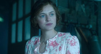 Movie still from “Lady Chatterley's Lover” (2022), directed by Laure de Clermont-Tonnerre – A woman with blue eyes wearing a white and pink dress; Close Up shot, Over the shoulder angle