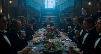 Movie still from “Lady Chatterley's Lover” (2022), directed by Laure de Clermont-Tonnerre – A group of people sitting around a dinner table; Wide shot, High angle