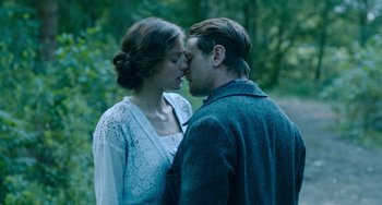 Movie still from “Lady Chatterley's Lover” (2022), directed by Laure de Clermont-Tonnerre – A man and a woman kissing in a forest; Medium shot, Low angle