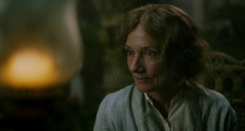 Movie still from “Lady Chatterley's Lover” (2022), directed by Laure de Clermont-Tonnerre – An older woman is looking into the distance; Close Up shot, Over the shoulder angle