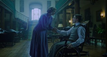 Movie still from “Lady Chatterley's Lover” (2022), directed by Laure de Clermont-Tonnerre – A man and a woman are shaking hands in a room; Medium shot, Low angle
