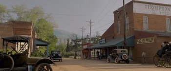 Movie still from “Lawless” (2012), directed by John Hillcoat – An old car parked on the side of the street; Extreme Wide shot, Low angle