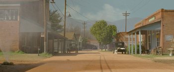 Movie still from “Lawless” (2012), directed by John Hillcoat – An oil painting of an empty street in a rural area; Extreme Wide shot, High angle