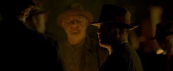 Movie still from “Lawless” (2012), directed by John Hillcoat – A man in a hat and a man in a hat; Close Up shot, Low angle